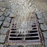 Stormwater rushing into a storm drain