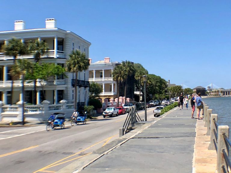 A photograph of Charleston in 2019 showing pedestrians walking along the High Battery