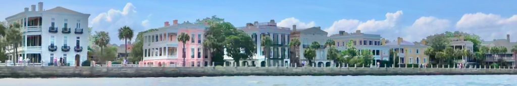 A panoramic view of the High Battery from the vantage point of Charleston Harbor with a row of large homes of many colors.